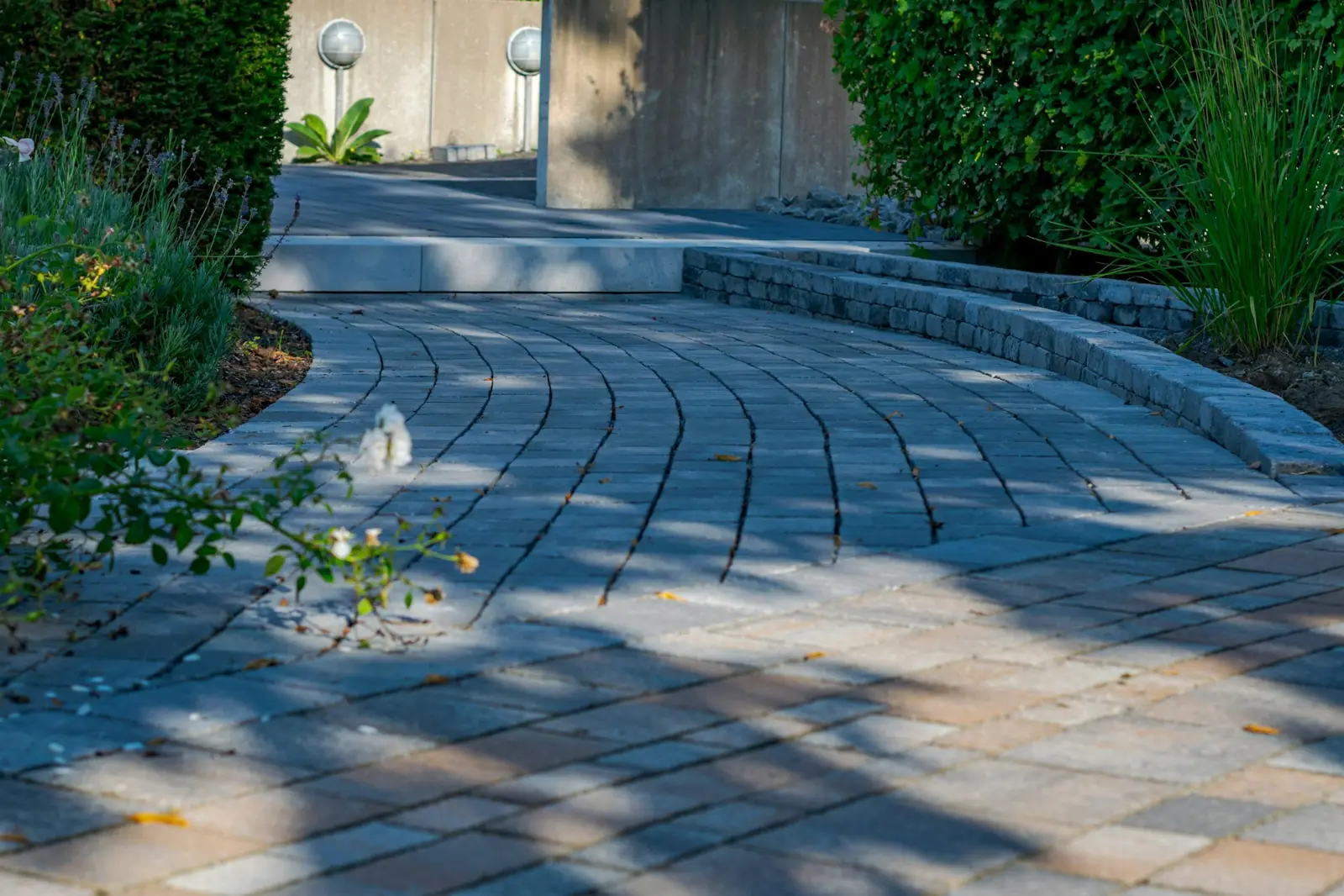Curved block-paved driveway with low walls